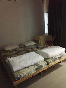 a pair of beds sitting in a room at Retkeilymaja Virkkula in Kuopio