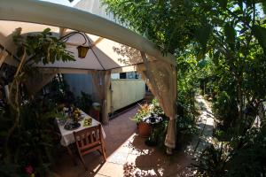 an outdoor patio with a table and an umbrella at B&B Mare E Sole in Brindisi