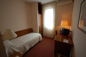 Postel nebo postele na pokoji v ubytování Albergo Ponte Vecchio