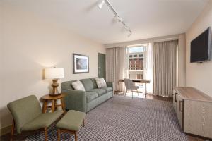 a living room with a couch and a tv at Hilton Birmingham Downtown at UAB in Birmingham