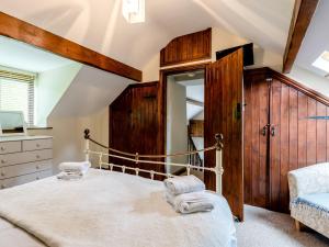 an attic bedroom with a bed and a mirror at 1 Bed in Llangollen 78471 in Glyn-Ceiriog