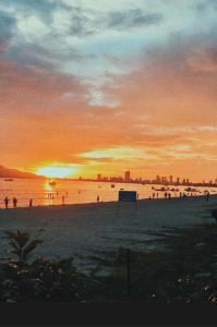 a group of people on a beach at sunset at Thai Binh Motel in Danang +7 photos
