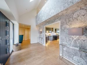 a living room with a stone wall with a flat screen tv at 5 Bed in Madley 78646 in Madley +30 photos