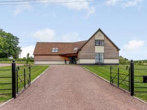 a barn with a driveway in front of it at 5 Bed in Madley 78646 in Madley