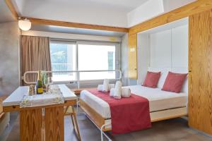 a bedroom with a bed and a desk and a window at Appartamento Samantha Residence Solaria Marilleva 1400 in Marilleva