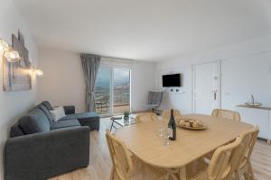 a living room with a table and a couch at La Bahia in Santa Cruz de Tenerife