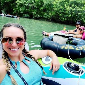 a girl is sitting on a raft in the water at Exciting Family Vacation with Kayaks, Canoes, and More: Comfortable Bell Tent near New Braunfels, Texas in Second Crossing