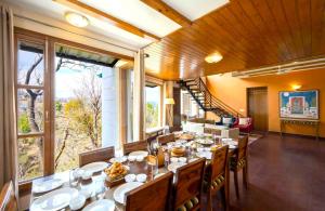 a dining room with a long table with food on it at Juniper6 BR Mountain View Villa Cook Staff Deck in Parwanoo