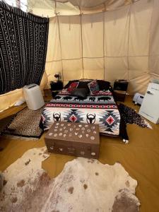 a bedroom with a bed with a bed frame with a bed sqor at Spacious Tipi with Outdoor BBQ and Fire Pit in Texas in Marble Falls