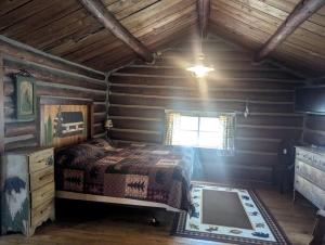 a bedroom with a bed in a log cabin at Secluded Lakeside Log Cabin Ideal for Couples Getaway' in Hayward, Wisconsin in New Post
