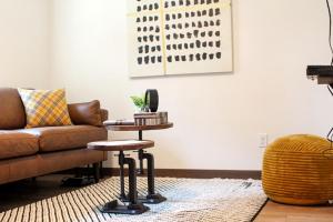 a living room with a couch and a table at Black Hills Glamping Cabin, Perfect for an Outdoor Adventure in Hill City