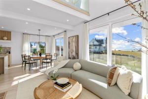 a living room with a couch and a table at Peaceful Oceanfront Villa in Bourne, Massachusetts in Patuisset