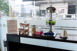 a table with a lamp and other items on it at Koho Hotel - Johor Bahru in Johor Bahru