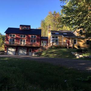 a large house with a large yard in front of it at Gorgeous Eco-Friendly Cottage Rental with a Gazebo in Jamaica, Vermont in Jamaica +9 photos