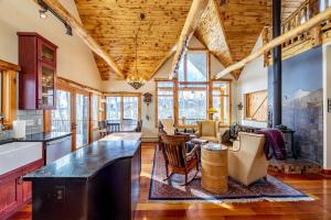 a kitchen with wooden ceilings and a living room at Charming Vacation Rental in the Heart of South Park near Fairplay, Colorado in Jefferson