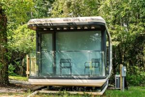 a bus with two chairs in the back of it at Modern Airstream Glamping with Pond Views in Rural South Carolina in Saint Stephen