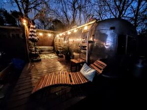 a train car sitting on top of a wooden deck at Sleek Retro Airstream Rental for Glamping for Two near Downtown Austin in Austin +19 photos