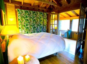 a bedroom with a bed and a lamp and a wall at Unique Cabin Vacation Rental for Large Groups on the coast of Lake Michigan near Saugatuck, Michigan in Pier Cove