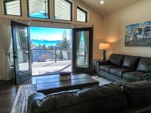 a living room with a couch and a table at Lake Cabin with Equipped Deck and Hot-Tub in Montana in Lakeside