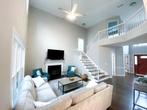 a living room with a white couch and a fireplace at Disconnect at this Cottage with Great Surroundings in Charlotte, North Carolina in Charlotte +50 photos