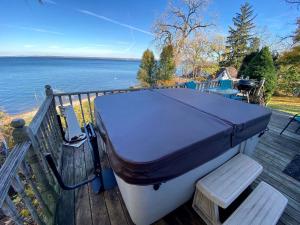 una barca appoggiata su un ponte vicino all'acqua di Lakefront Cottage with Cozy Interior and Jacuzzi in Dresden, New York a Dresden