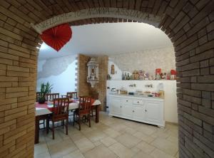 a kitchen and dining room with a table and a brick wall at B&B Nonna Assunta in Collegiove +18 photos