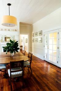 a dining room with a wooden table and chairs at Historic Plantation House Suite with a Stone Fireplace in Ridge Spring, South Carolina in Ridge Spring