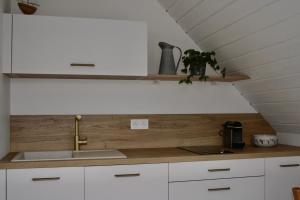 a kitchen with white cabinets and a sink at TyGroaz studio in Porspoder in Porspoder