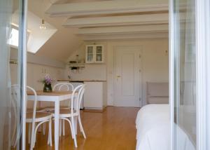 a kitchen and dining room with a table and chairs at Guest House Vitaja in Bled