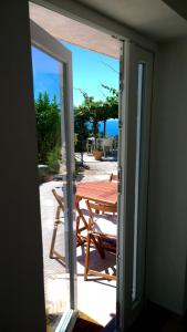 a sliding glass door leading to a patio with a table at Le Paradis in Levanto