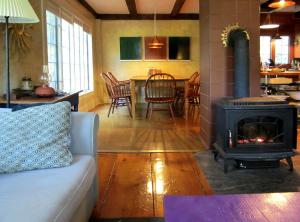 a living room with a couch and a stove at Gorgeous, Lakefront Vacation Rental in the Charming Town of Wayne in Central Maine in Wayne +12 photos