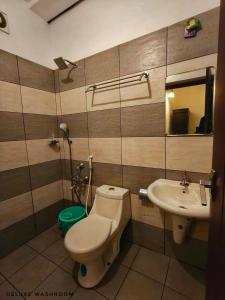 a bathroom with a toilet and a sink at Casalinda munnar by Foxinroom in Devikolam