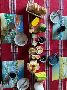a table with plates and bowls and bread on it at Chambre dans Maison basque typique in Amendeuix-Oneix