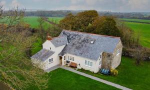 an aerial view of a large white house in a field at Colemans Retreat in Porchfield