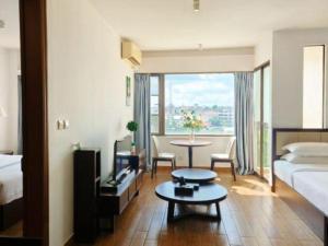 a hotel room with a bed and a table in a room at Sky City Hotel in Ban Phôn Khéng +155 photos