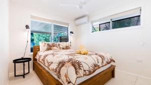 a bedroom with a bed and a window at Family Holiday Fun Right Here in Bongaree