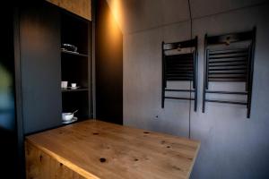 a kitchen with a wooden table in a room at Luxurious Cabin Rental with a Hot Tub near Maribor for Glamping in Slovenia in Brestrnica