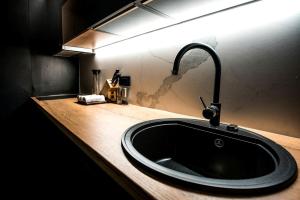 a bathroom sink with a black sink at Luxurious Cabin Rental with a Hot Tub near Maribor for Glamping in Slovenia in Brestrnica +10 photos