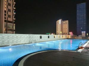 a large swimming pool in a city at night at FLC Luxury Quy Nhon-Sea view - An Apartment in Quy Nhon