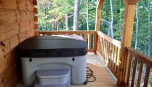 a toilet sitting on the porch of a cabin at Authentic Stunning Cabin Rental with Private Jacuzzi near Huntington, West Virginia in Genoa