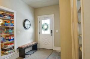 a hallway with a white door and a shelf with books at Luxurious Pet-Friendly Vacation Rental close to Mirror Lake in Kamas, Utah in Kamas
