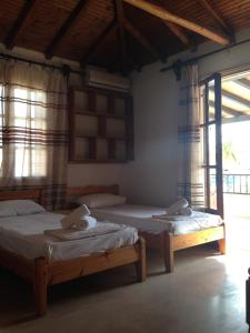 a bedroom with two beds and a window at Maria in Skiathos Town