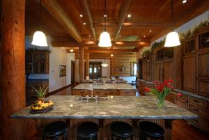 a large kitchen with a large island with bar stools at Deluxe Vacation Suite with Private Bathroom in Melrose, Montana in Divide
