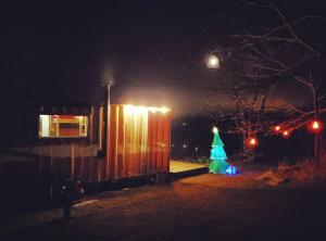 a christmas tree in a yard at night at Rustic Container Accommodation for Glamping in Kentucky in Owenton