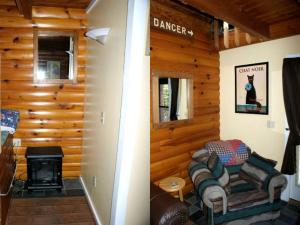 a living room with a fireplace in a log cabin at Rustic Cabin Rental near the Ski Slopes in Snowshoe, West Virginia in Snowshoe