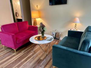 a living room with a red couch and a table at Remote Vintage Camper Rental for Adult-Only Retreat in Franklin, North Carolina in Franklin