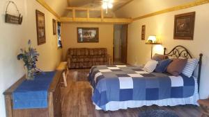 a bedroom with a bed and a couch at Cozy Cabin on Horse Ranch near Kalispell, Montana in Kila