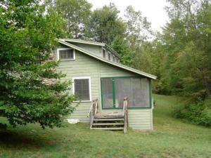 a small house in the middle of a yard at Lake Vacation Rental for Eight-People in the Adirondacks, New York in Severance