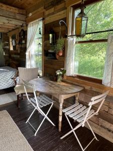 un tavolo in legno e 2 sedie in una cabina di Gorgeous Tiny House Rental for a Glamping Getaway near Saratoga Springs in Upstate New York a Argyle
