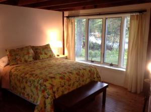 a bedroom with a bed and a large window at Secluded Cabin with Gorgeous Views near Stockbridge in the Berkshires of Massachusetts in Housatonic